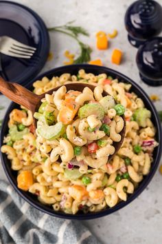 a bowl filled with macaroni salad on top of a table