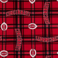 a red and black plaid fabric with the word, university of cincinnati in white on it