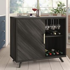 a cabinet with wine glasses and bottles in it