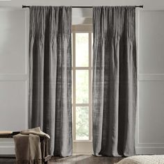 the curtains in this bedroom are made from gray linen