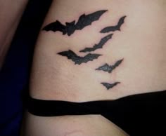 a woman's stomach with bats on it