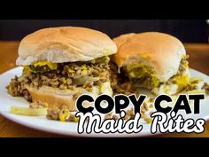 a couple of sandwiches sitting on top of a white plate with the words copy cat maid bites