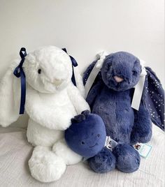 two stuffed animals sitting next to each other