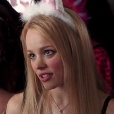 a woman with long blonde hair wearing bunny ears