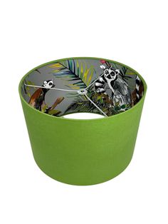 a green bowl with an image of a panda bear and palm leaves on the side