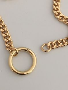 This is a high quality thick, brass, gold plated chain necklace. Minimalist and modern chunky gold curb link chain necklace with a decorative spring lock connector. The curb/cuban link necklace is is a show stopping design and is a weighty brass necklace with 14k gold plating. Lead safe and Nickel safe. You have the option of adding your own pendant or enhancer to the connector. So Versatile ! Please note that the length ordered includes the size of the spring lock connector. The chain is 9mm wi Gold Metal Chain Link Ring, Gold Chain Link Ring Made Of Metal, Metal Chain Ring With Gold Link Chain, Metal Chain Ring With Link Shape, Cuban Link Metal Necklace With Adjustable Chain, Metal Cuban Link Necklace With Adjustable Chain, Metal Cuban Link Chain Necklace With Lobster Clasp, Adjustable Cuban Link Metal Necklace, Gold Plated Curb Chain Choker Necklace