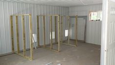 the inside of a storage room with metal partitions and walls in place for doors