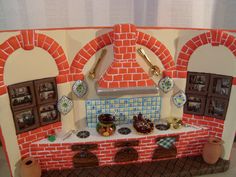 a cake made to look like a brick oven with pictures on the wall and windows