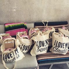 several bags sitting on top of a bench next to a bag filled with pink flowers