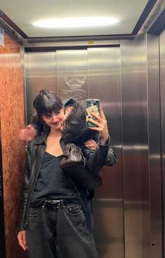 a woman taking a selfie in an elevator