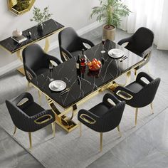 a black and gold dining table with six chairs around it in a living room setting