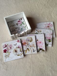 four cards in a box with flowers on them