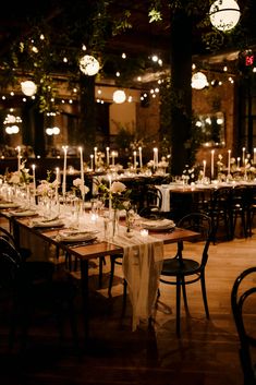 the tables are set with candles and place settings for an elegant dinner or reception at night