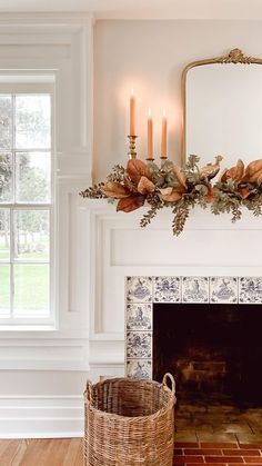 a living room with a fire place and a mirror on the wall next to it