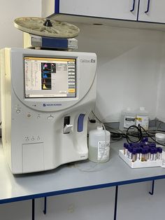 a medical machine sitting on top of a counter next to bottles and other items in front of it