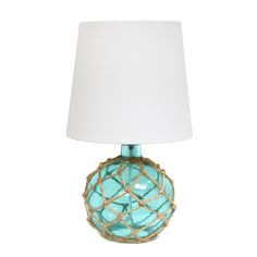 a blue glass table lamp with a white shade