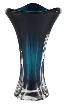 a blue glass vase sitting on top of a white table