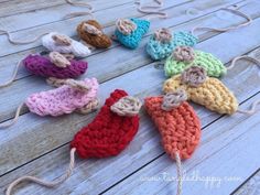 crocheted baby booties are arranged on a wooden surface