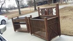 a baby crib sitting on the sidewalk next to a car