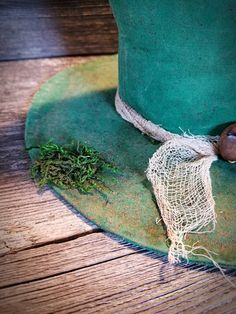 a green hat sitting on top of a wooden table