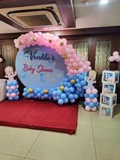 a balloon arch with balloons and decorations for a baby shower at a party or event