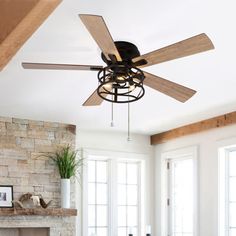 a living room with a fireplace and ceiling fan