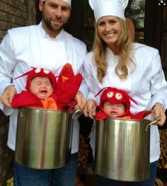 a man and woman are holding two babys in buckets