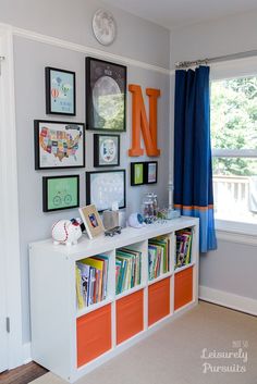 there is a book shelf with many books on it in the corner of this room