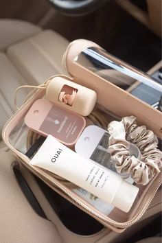 the contents of a purse are neatly packed in the back seat of a car,