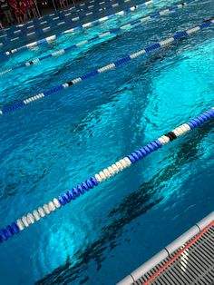 an empty swimming pool with blue and white lanes