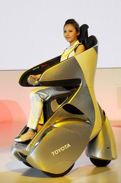 a woman sitting on top of a yellow motorcycle