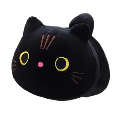 a black cat shaped pillow with yellow eyes