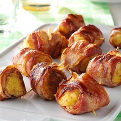 bacon wrapped potatoes on a white plate