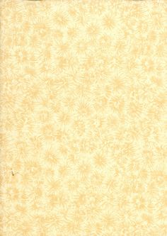 an old yellow paper with white flowers on it