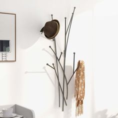 a coat rack and hat hanging on the wall