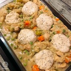 a casserole dish with chicken, dumplings and vegetables