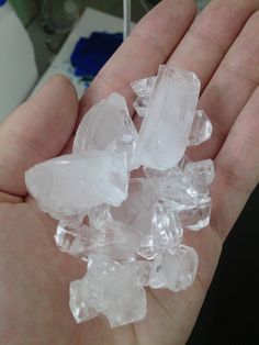 a person holding some ice cubes in their hand