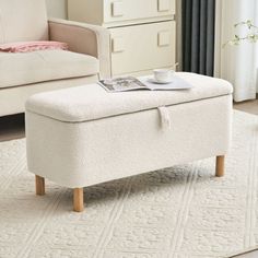 a white ottoman sitting on top of a rug in a living room