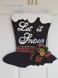 a christmas stocking hanging from the side of a white door that says let it snow