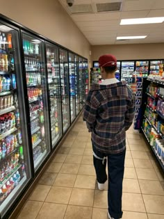 a man walking through a grocery store aisle