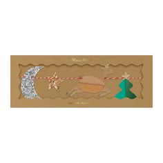 a christmas card with an ornament and reindeer on a string next to a tree