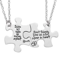 two pieces of puzzle necklaces with words on the front and back of each piece