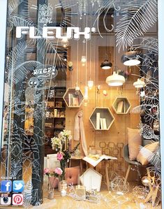 the front window of a furniture store with many items on display in it's windows