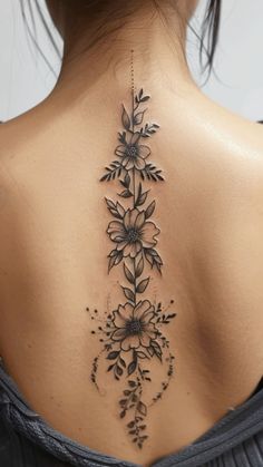 the back of a woman's neck with flowers on it