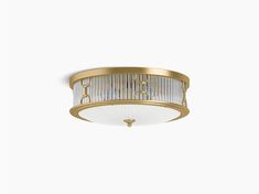 an image of a flush light fixture on a white wall with a gold trimming