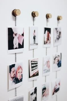 several pictures hanging on a wall with clothes pins attached to them and photos pinned to the wall