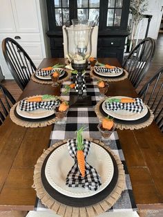 a dining room table set with black and white checkered placemats, carrots, and napkins