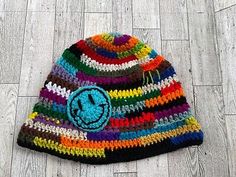 a multicolored hat with a smiley face on it