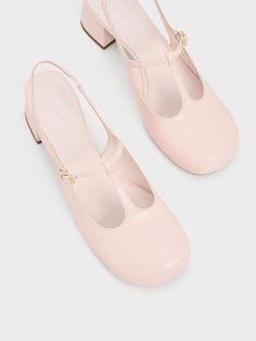 Add a girlish charm to your look with these T-bar Mary Jane pumps. Soft, rounded contours complement the delicate straps while the glossy light pink finish will instantly captivate those with a love for the colour. The simple and minimalist design also allows the sweet, pastel hue to shine. Fitted with elasticised slingback straps and set on sturdy 4.5cm block heels, these are shoes you can wear and walk in for hours. Brand Collaboration, Faux Leather Heels, Size Chart For Kids, Mary Jane Pumps, Charles Keith, Pastel Hues, Pink Shoes, Cut Out Design, Powder Pink