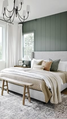 a bedroom with green walls and white bedding